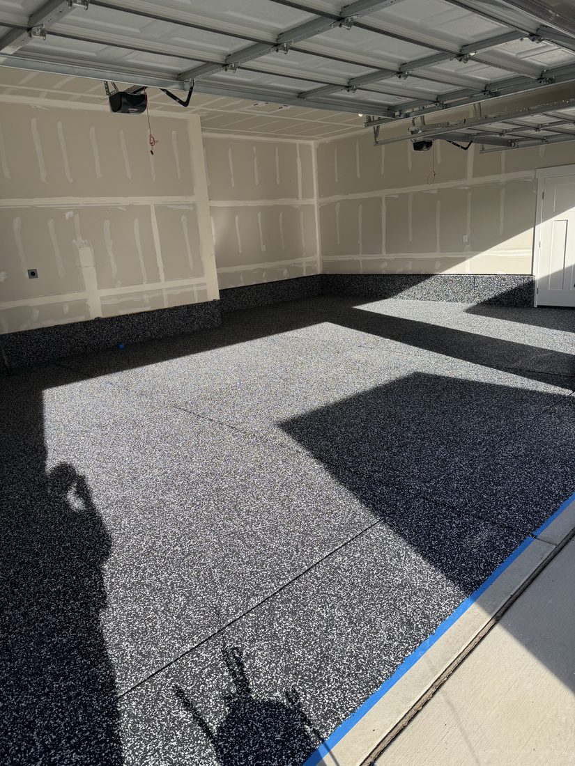 Garage flake epoxy floor with a matching flake cove base running up the walls