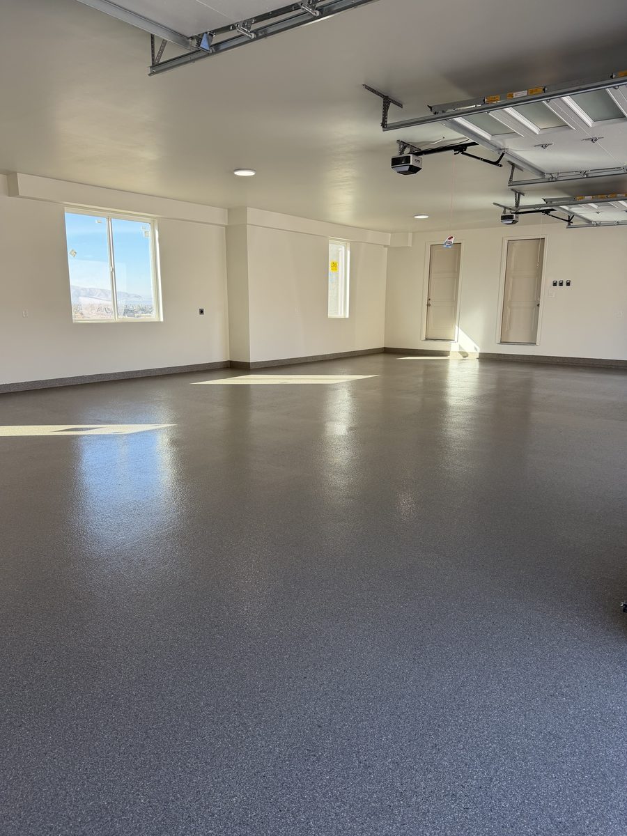 Bright, finished multi-car garage with a light-gray flake epoxy floor