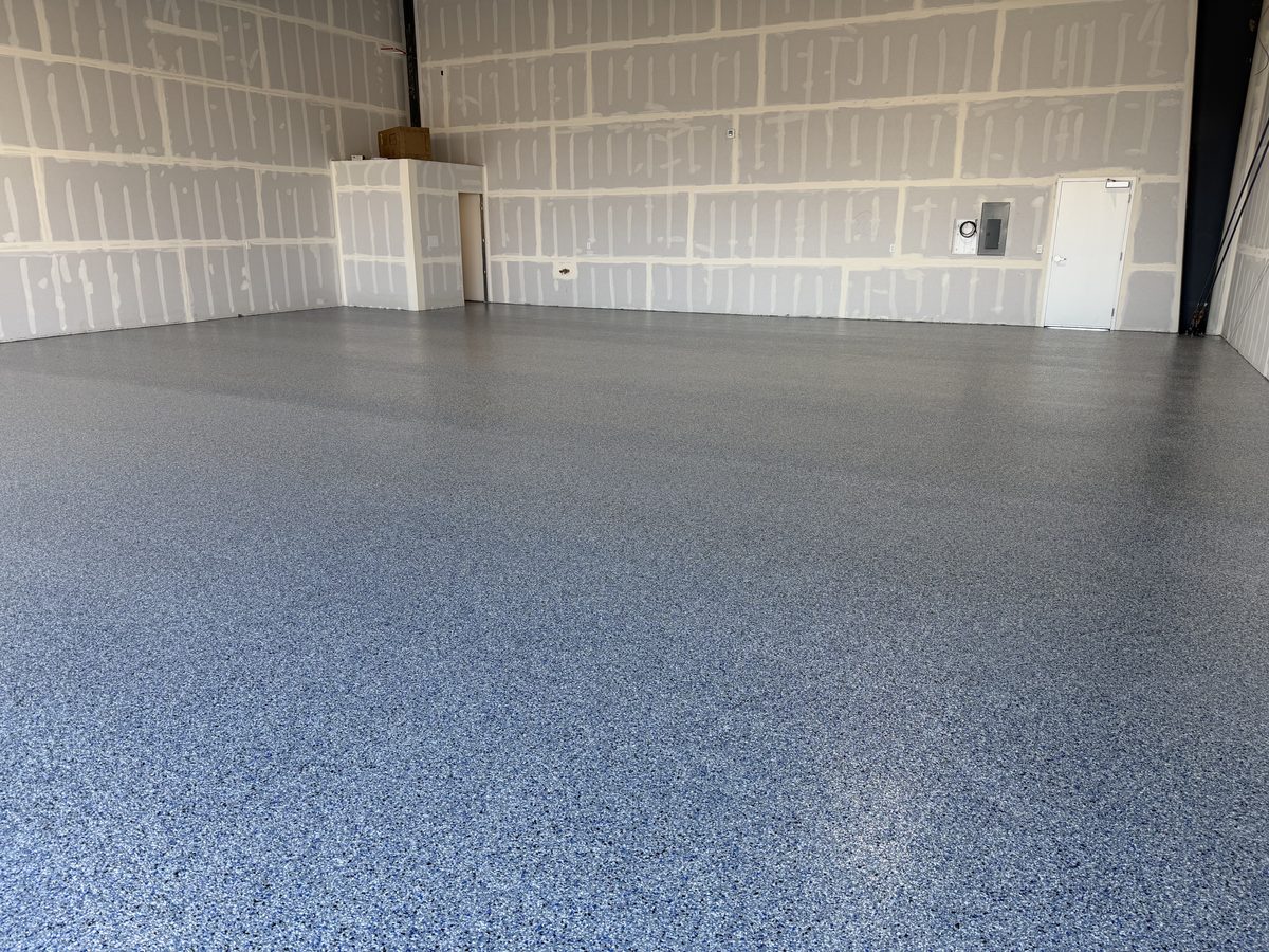 Large open space with an expansive blue-gray flake epoxy floor